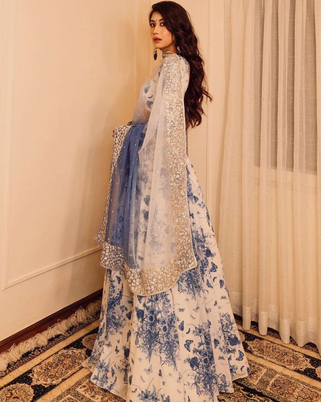 MINDBLOWING FLORAL WHITE LEHENGA CHOLI WITH BLUE FLOWERS